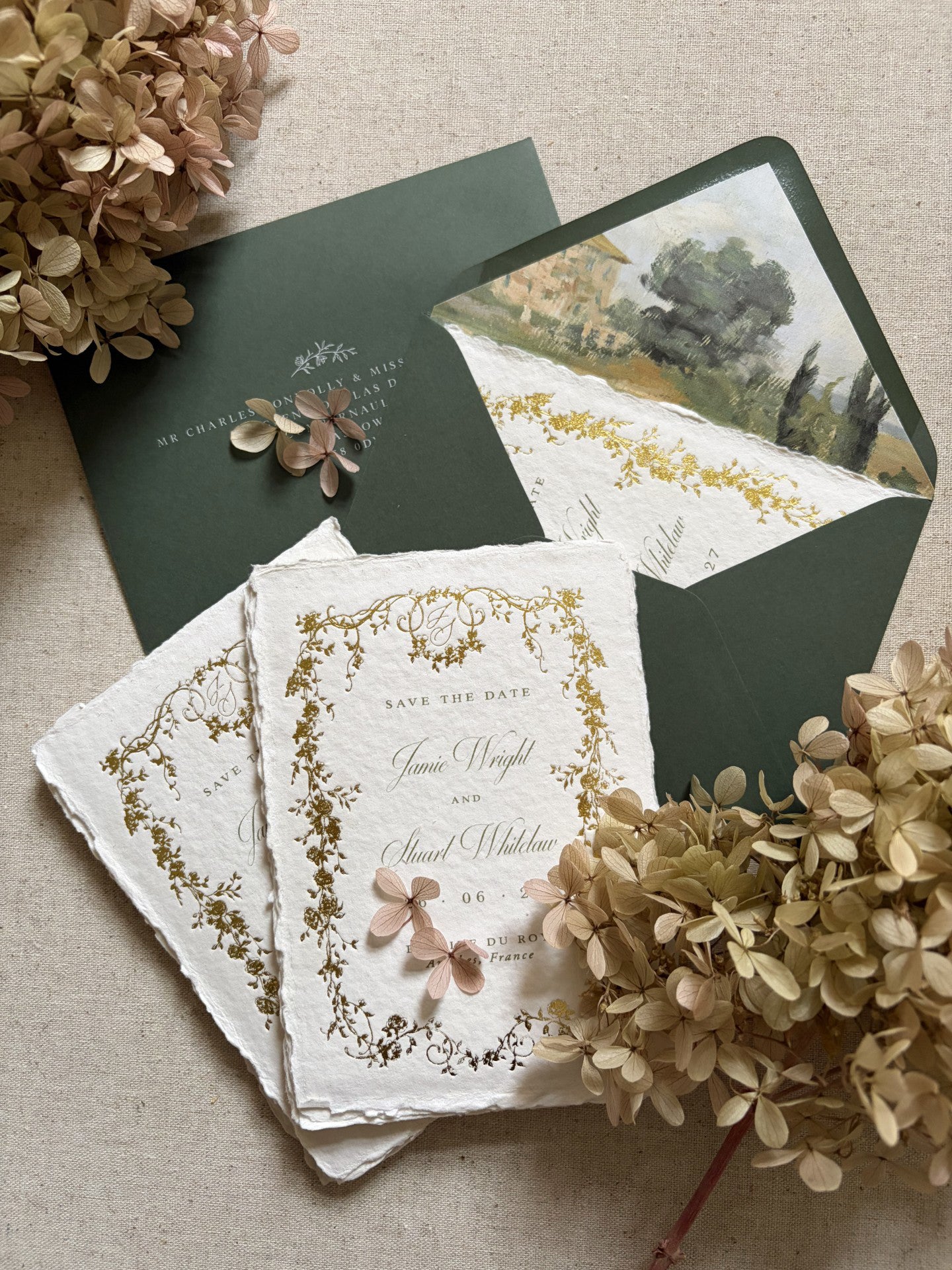 fine art floral wedding save the date cards with a vintage style gold foil floral border on handmade cotton paper, paired with khaki green envelopes with a vintage French chateau painted envelope liner, styled with dried hydrangeas
