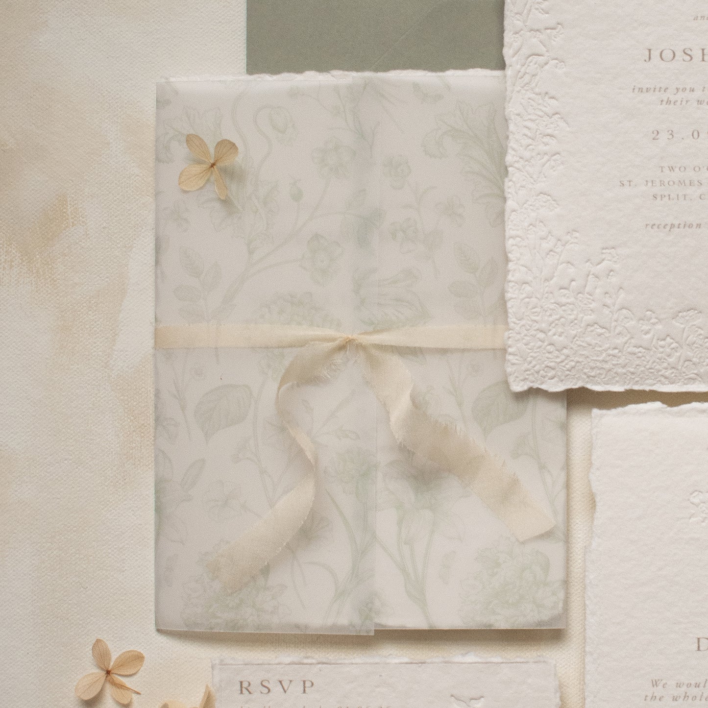 sage green floral vellum wrap with hand dyed silk ivory ribbon and white wax seal for wedding invitations