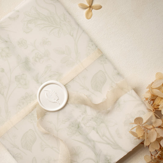 sage green floral vellum wrap with hand dyed silk ivory ribbon and white wax seal for wedding invitations
