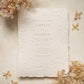 blind letterpress wedding invitation on handmade cotton paper with delicate floral detailing, styled with beige coloured dried hydrangeas