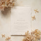 wedding details card with blind letterpress floral motif on handmade cotton paper, styled with dried flowers
